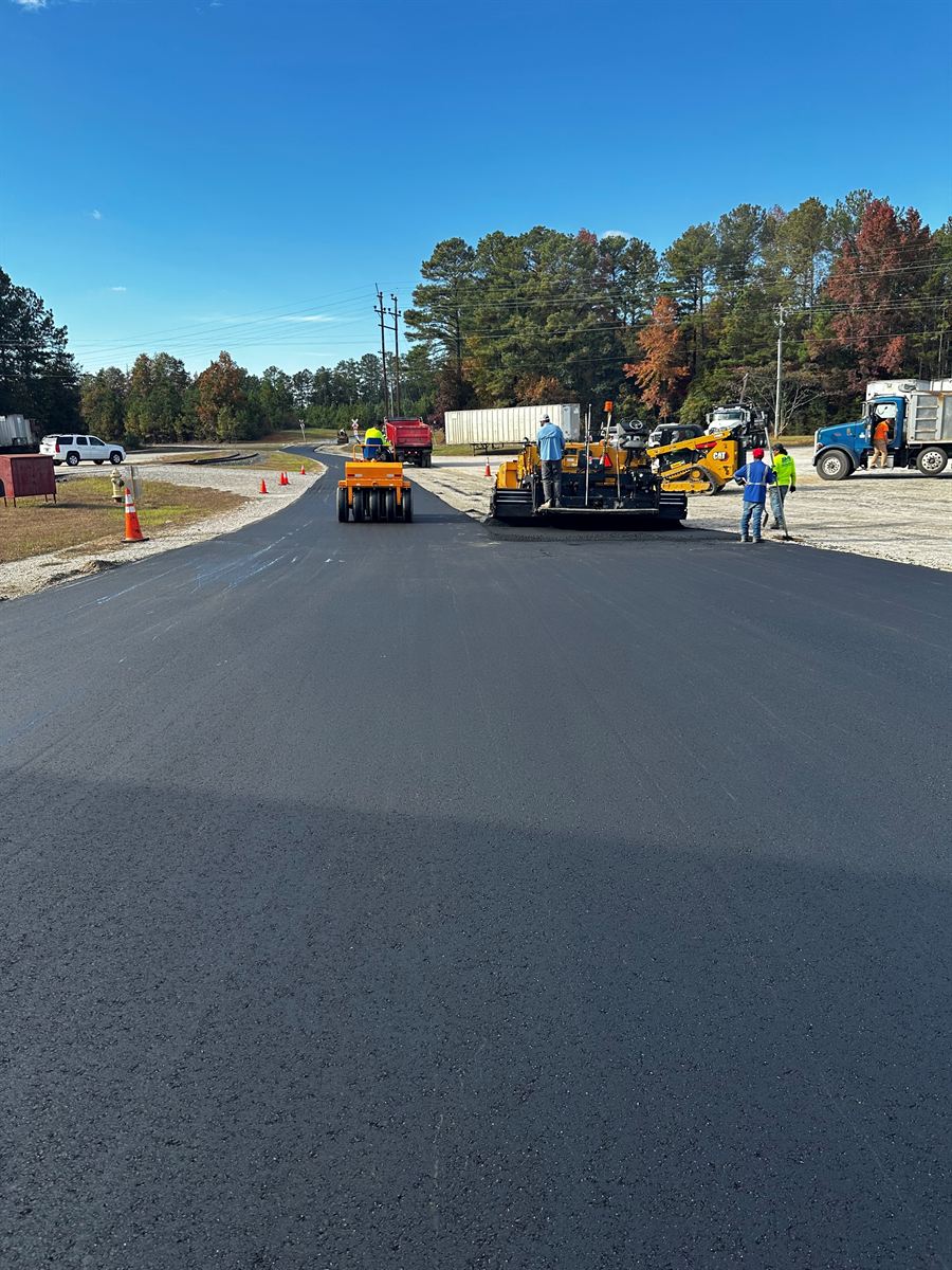 ECA paver and roller laying fresh hot-mix asphalt