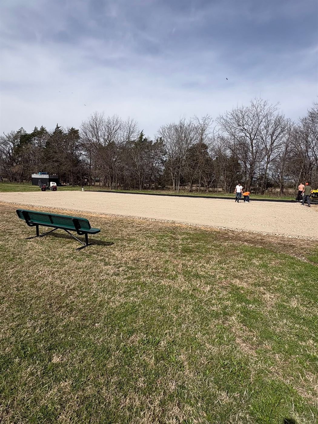 ECA crew grading and compacting a gravel base before paving